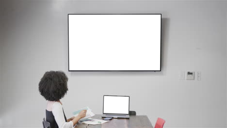 mujer de negocios afroamericana en una videollamada con pantalla en blanco