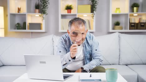 Man-looking-at-camera-with-magnifying-glass.