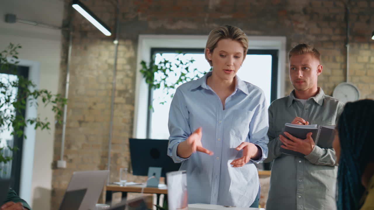Woman ceo talking employees on office meeting explaining project close up.