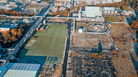 Aerial-footage-moving-towards-a-large-industrial-chemical-plant,-showing-pipelines,-metal-structures,-cooling-towers-and-chemical-storage