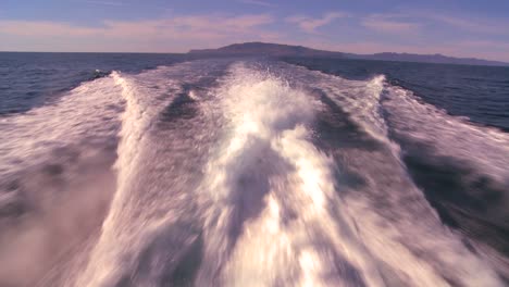 pov from the back of a boat motoring through the waters off santa barbara california