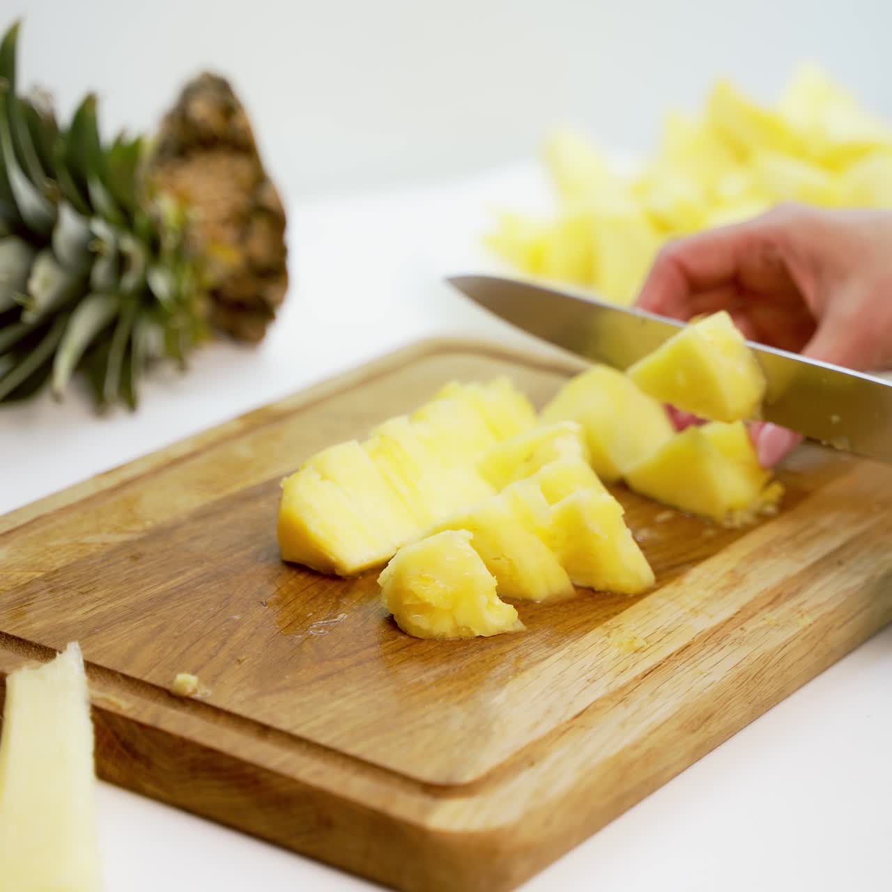 Board with delicious cut pineapple on table