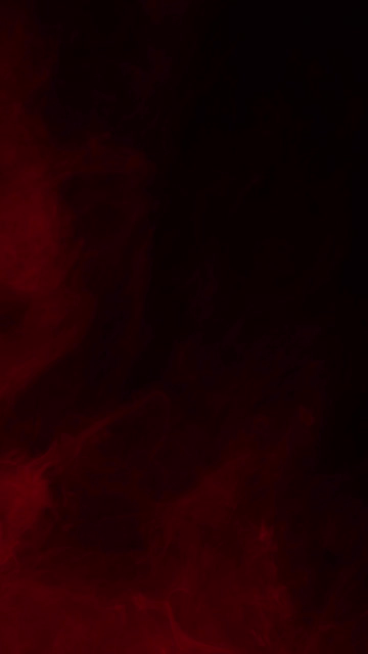 Slow moving dark red clouds or smoke swirl to create a moody and atmospheric texture, abstract background for horror or dramatic projects, vertical format
