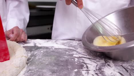 two chefs preparing a pie