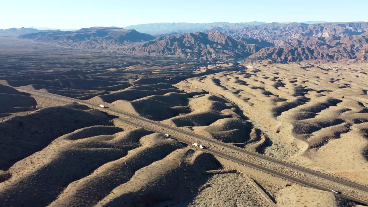 US, AZ, Hoover Dam, Hwy 93, 2025-01-15 - Drone view flying over the desert near US Hwy 93 near the Hoover Dam with the Colorado River visible in the distance, at sunrise