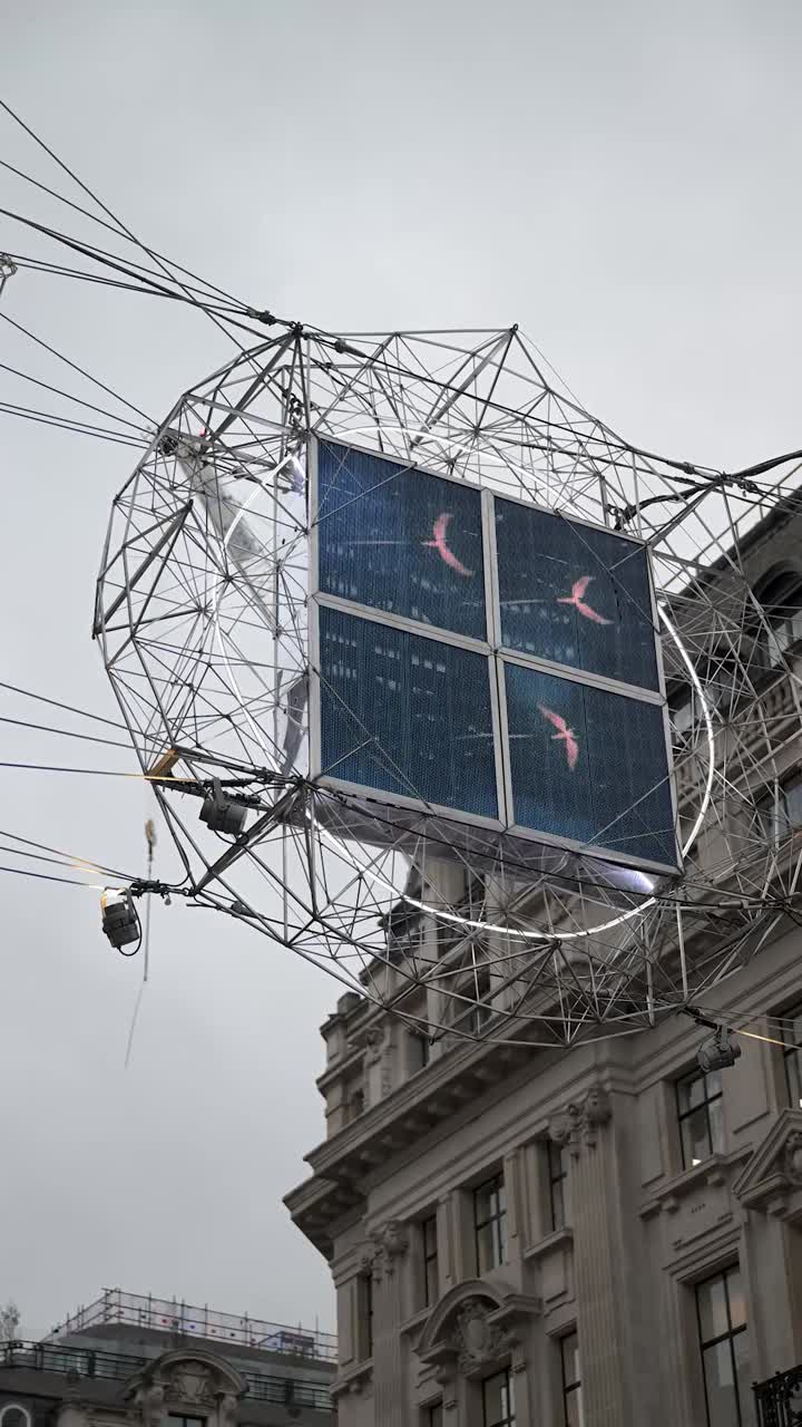 Festive angels and lights fill Regents Street during Christmas creating a joyful atmosphere above the busy shopping avenue