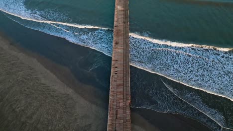 aerial shot of the pier on a beach in pacasmayo at 7