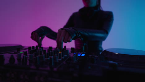 a female dj performing at a nightclub