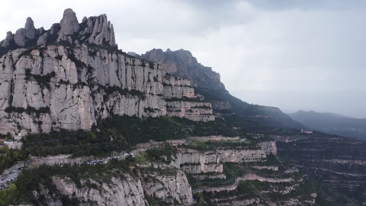 Wide view of Montserrat mountain ridge under cloudy sky in Catalonia, Spain