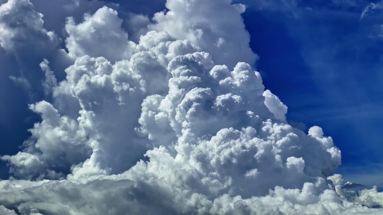 Aerial view of dramatic cumulus clouds towering above a deep blue sky over Dondra Head