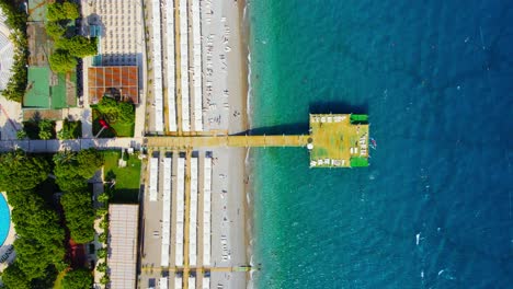 aerial 4k drone wide top down video of a wooden pier near hotel resort in the city of kiriş - kemer