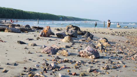 thailand beach with pebbles and rocks revealing the ocean waves in background