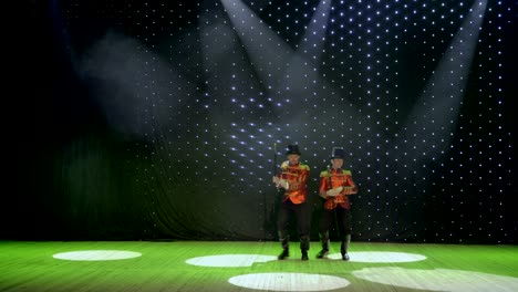 artistic gentlemen are dancing on stage in theatre