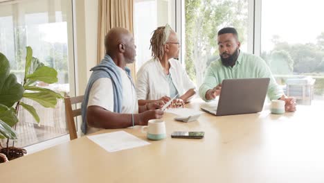 African-american-financial-advisor-and-senior-couple-talking-at-home,-slow-motion