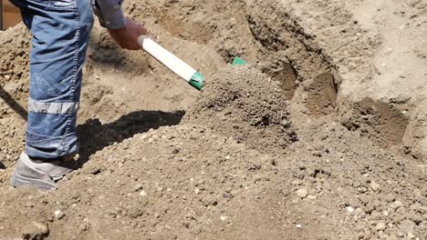 construction worker using a shovel to move dirt