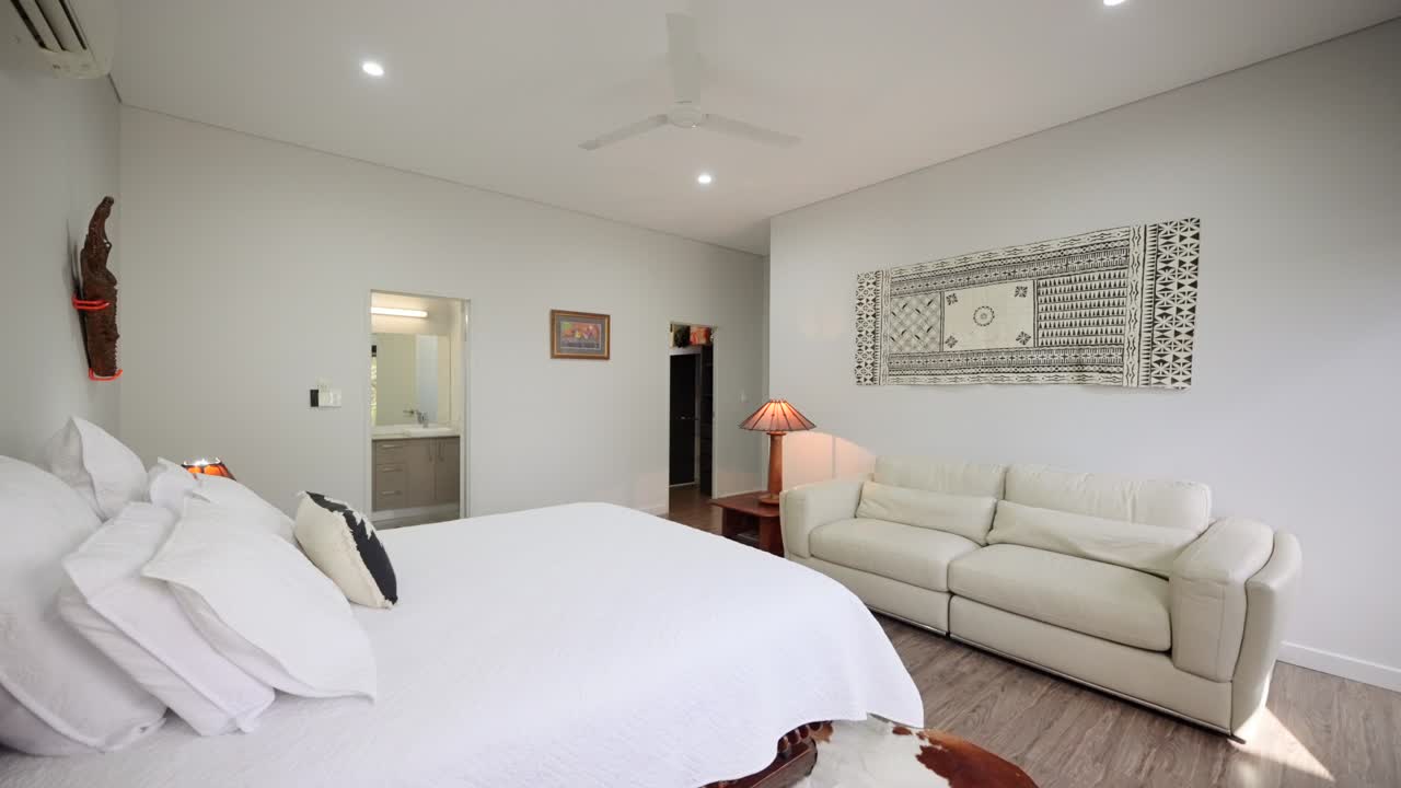 Modern bedroom interior with sleek furniture and natural lighting, creating a cozy, minimalist atmosphere. Interior of house home staged for real estate.