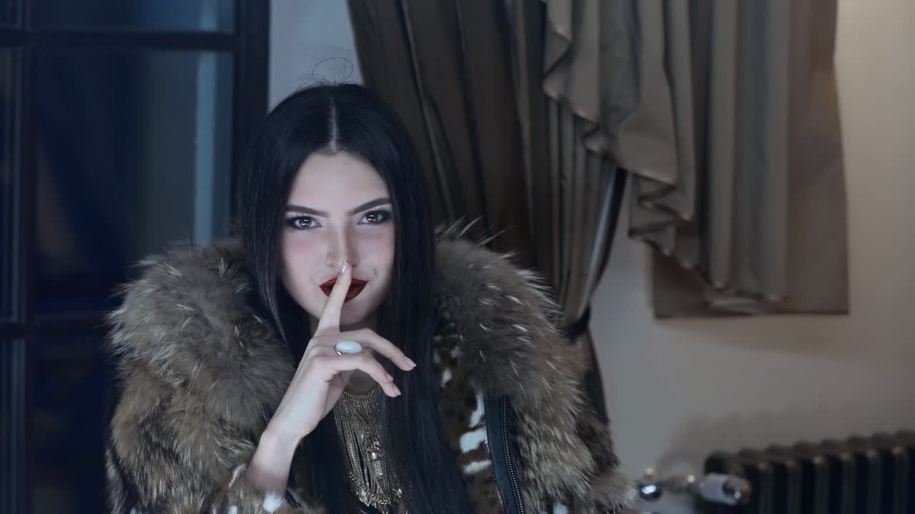 Beautiful brunette in fur coat posing on camera