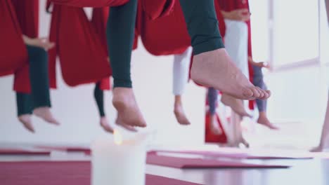 ladies with bare feet practice butterfly fly yoga pose