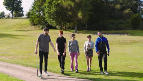 golf players playing golf together, walking with clubs on a golf course on a sunny day