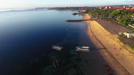 moored traditional indonesian boats near sandy coast, aerial view