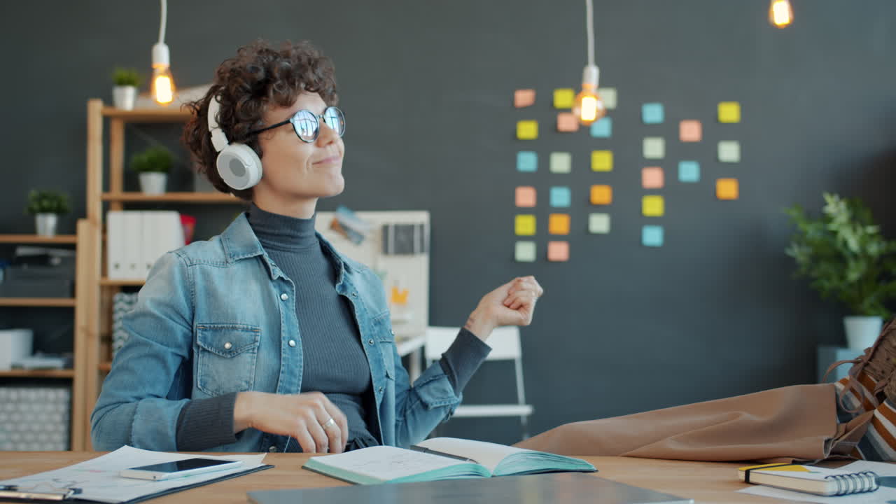 Woman enjoying music in the office