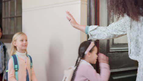 high five, teacher and students walking in school