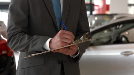 man in a suit signing a document