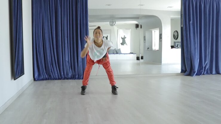 Excited woman dancing in studio