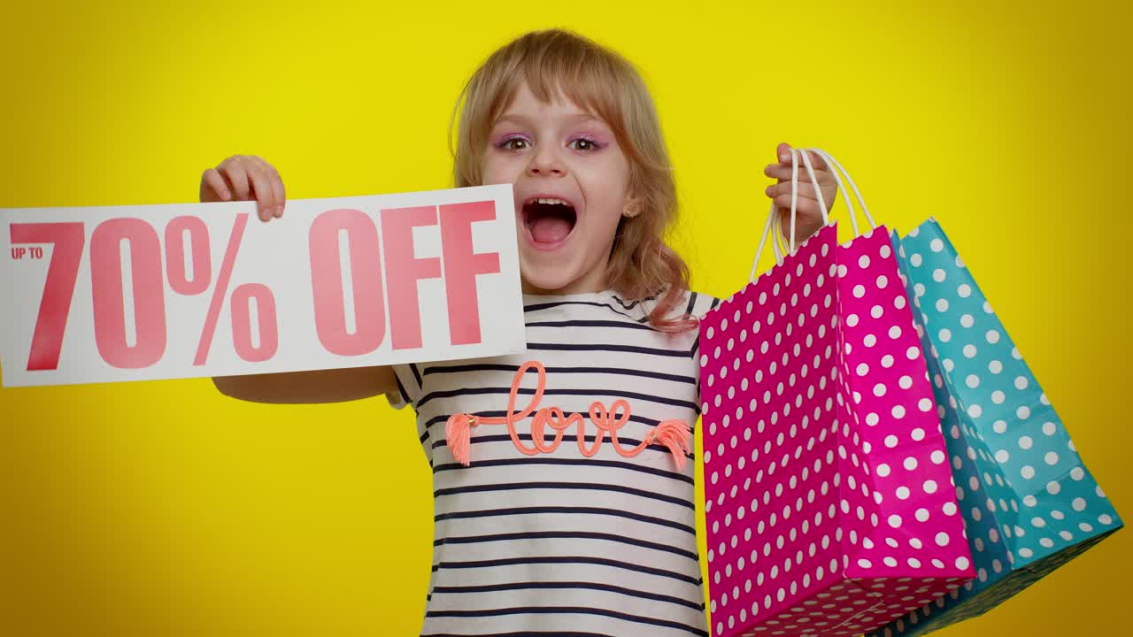 Child kid girl showing shopping bags and Up To 70 Percent Off inscriptions banner text, Black Friday