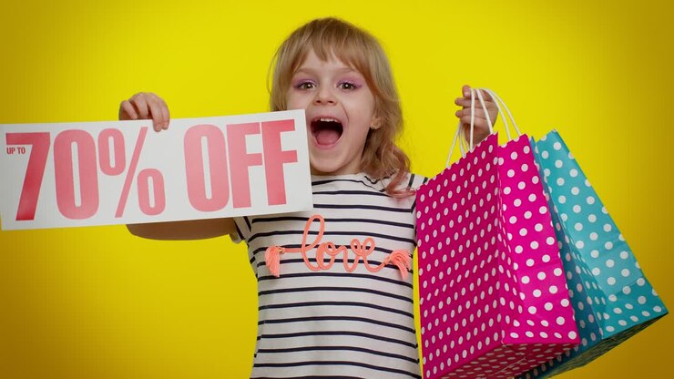 Child kid girl showing shopping bags and Up To 70 Percent Off inscriptions banner text, Black Friday
