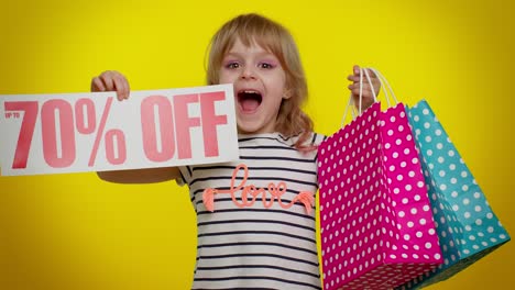 Child-kid-girl-showing-shopping-bags-and-Up-To-70-Percent-Off-inscriptions-banner-text,-Black-Friday