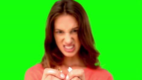 Woman-breaking-a-cigarette-on-green-screen