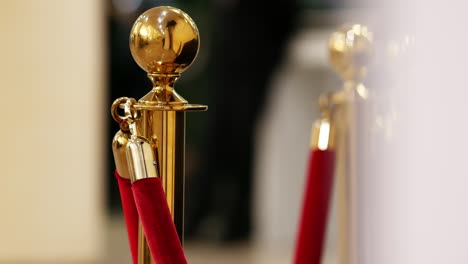 velvet red luxury ropes closed at valuable exhibit in museum or vip zone concert