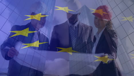 composite video of european union flag over diverse male and female engineers discussing plan