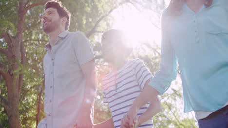 family walking in the park on a sunny day