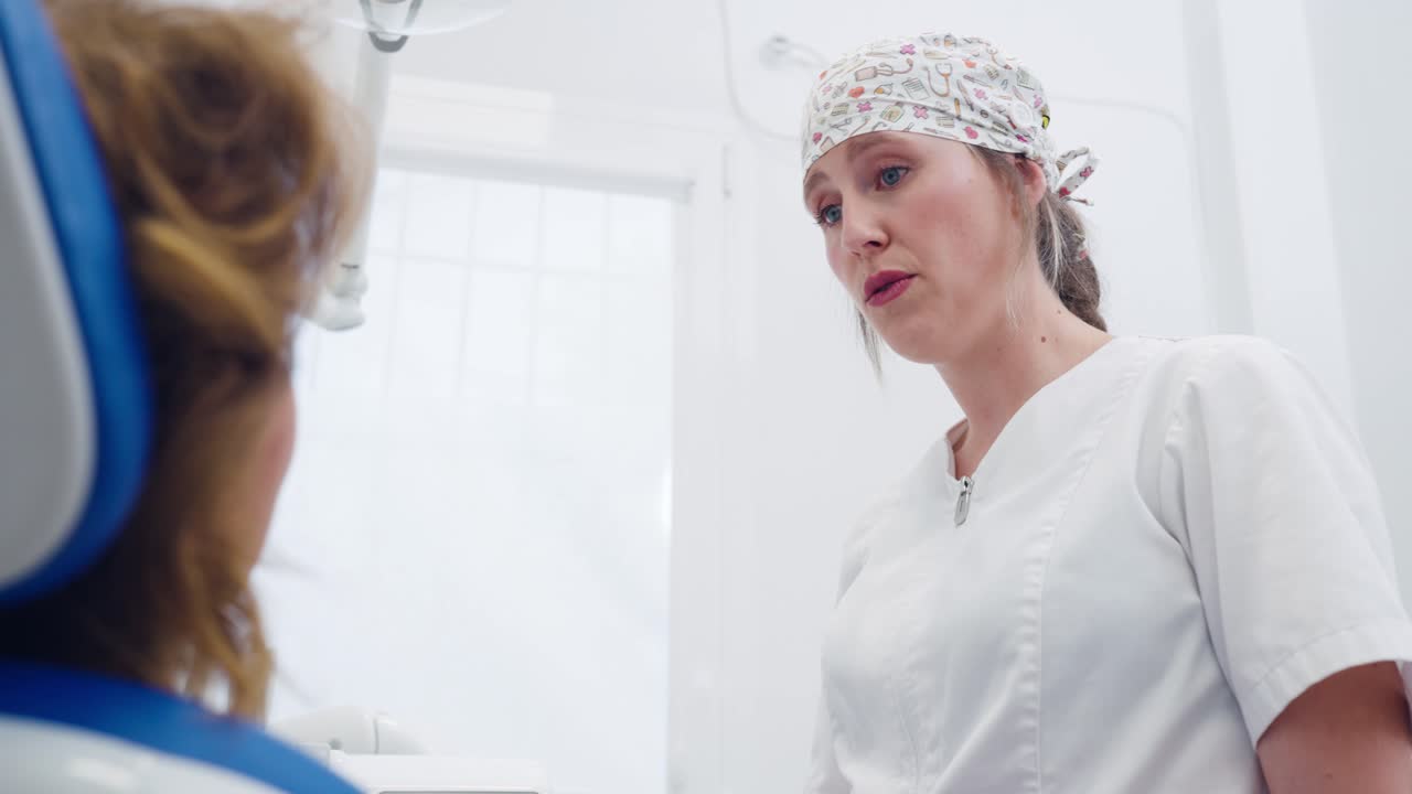 Dentist consulting with patient in dental office