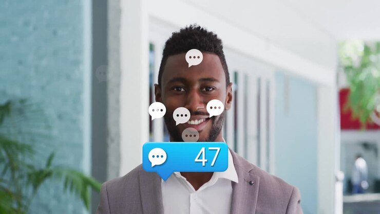 Receiving multiple chat notifications, man in office smiling at animation on screen