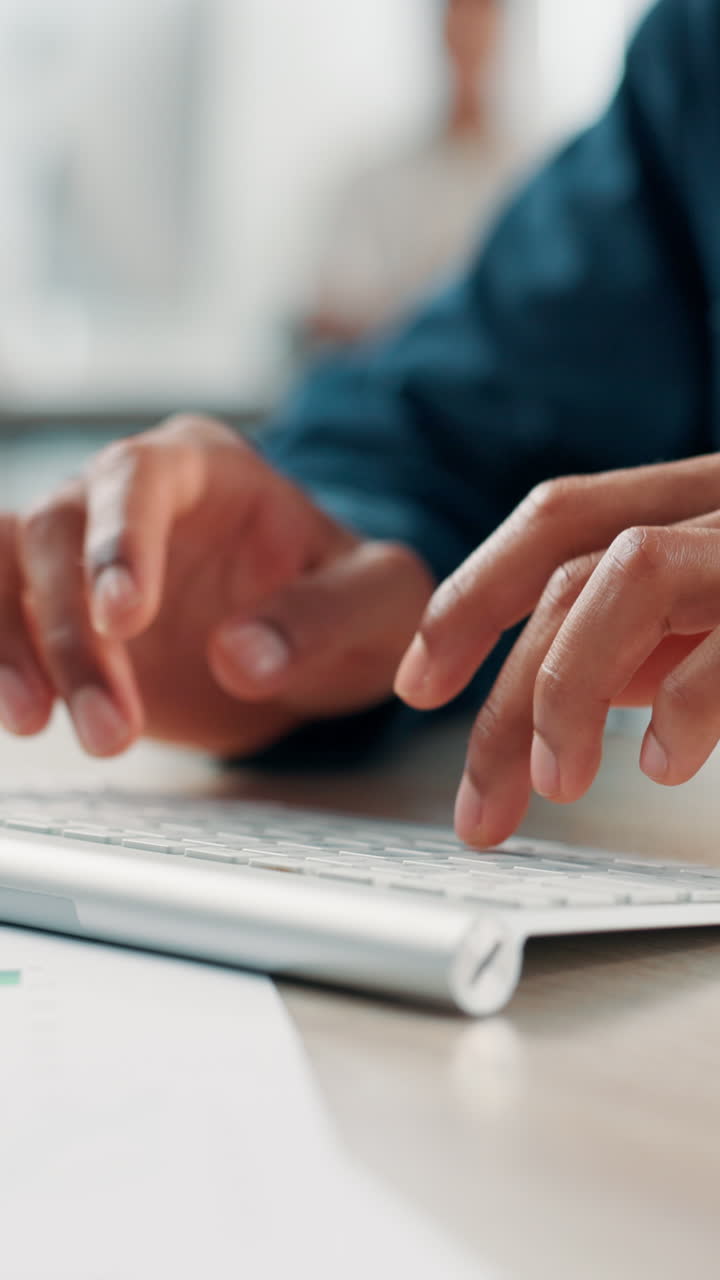 Close-up of Hands Typing on a Computer Keyboard in an Office