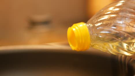 pouring cooking oil into a pan