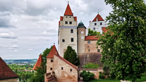 historic trausnitz castle tower and rooftops in landshut with cloudy sky background
