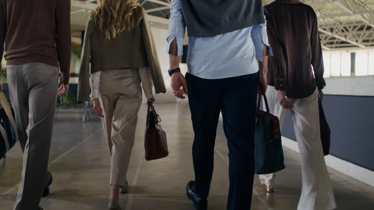 Business People Walking in a Corridor