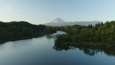 Aerial,-Lush-Trees-Around-Lake-with-Mount-Taranaki-in-Background