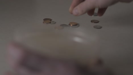 gathering up change and coins from a countertop