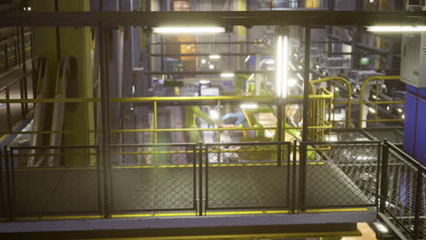 nighttime view of an industrial facility with machinery and workstations