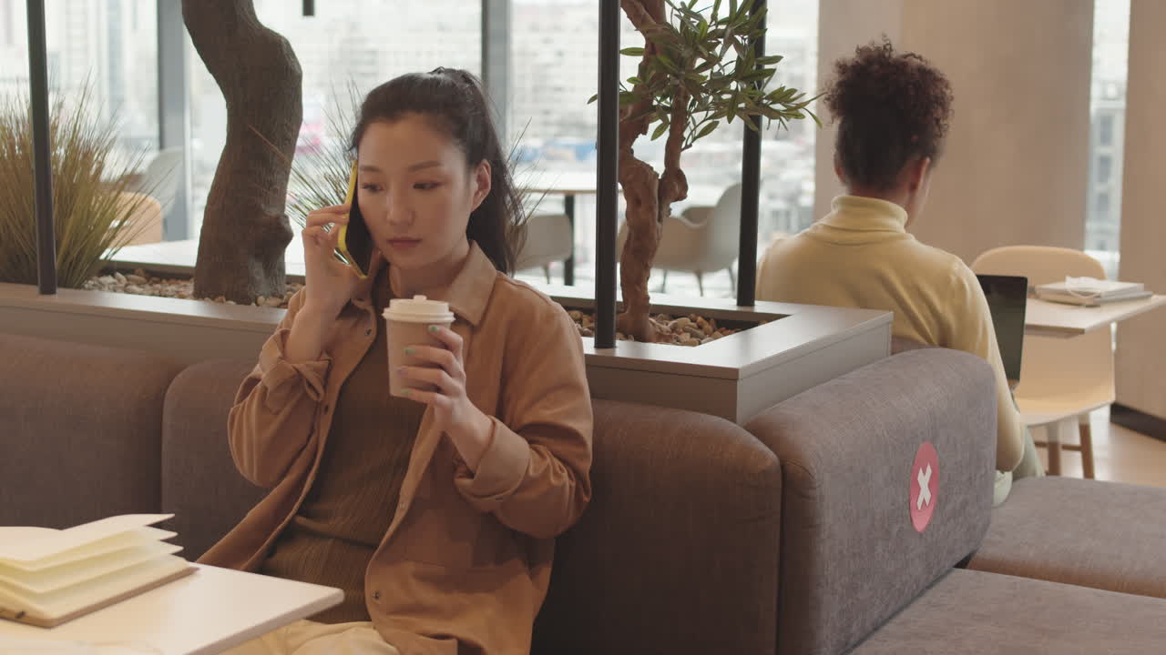 Woman Talking on Phone Drinking Coffee