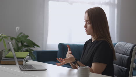 young-female-teacher-is-teaching-by-internet-speaking-to-web-camera-of-laptop-distant-education-in-school-college-and-university