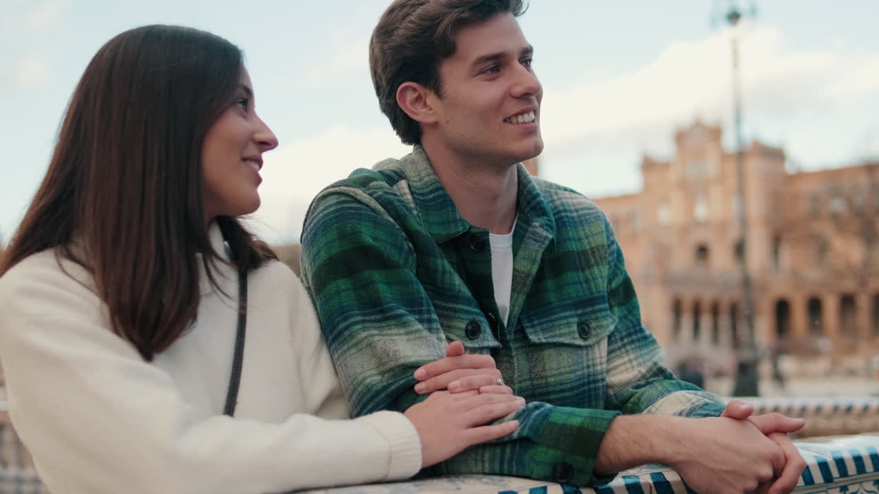 Close up, happy young partners man and woman talking and laughing standing on old