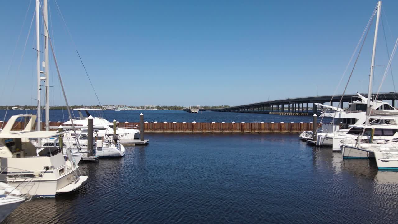 Aerial of sailboats docked at a marina in Bradenton, Florida on a clear sunny day with calm waters.