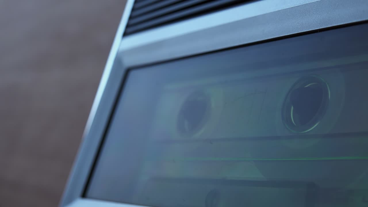 Audio cassette tape rolling in vintage player