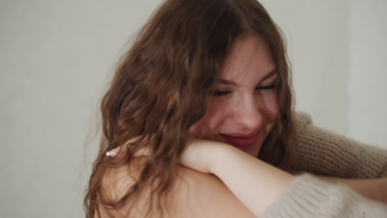 Caucasian Woman Closeup Face And Hair, Soft Curls Framing Shy Smile And Downward Gaze, Natural Light Highlights Texture And Skin, Intimate Portrait Mood With Gentle Expression And Relaxed Posture